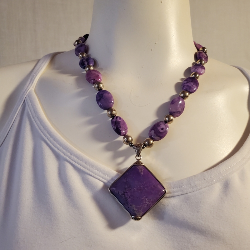 Purple stone bead necklace with square pendant.